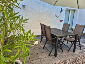 a wooden table and chairs sitting on a patio at Ferienwohnung Schorfheide Krüger in Joachimsthal