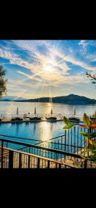 a view of a large body of water with the sun at Resort Antico Verbano in Meina