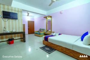 a hotel room with a bed and a tv at Hotel Oasis International in Cox's Bazar