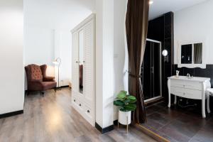 a living room with a sink and a desk at Nidhra Lanna Hotel Chiang Mai in Chiang Mai