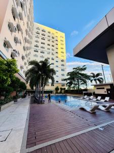 a swimming pool in the middle of a building at JFam Suites, C4-11K Studio, Up To 4 Pax in Biñan