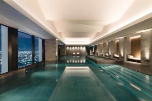 a swimming pool in a building with a view at Conrad Nagoya in Nagoya