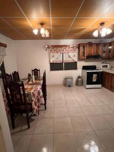 a dining room with a table and a kitchen at Comfortable 3-bedroom, 1-kitchen cottage in Cerro Punta +24 photos