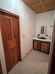 a small kitchen with a door and a sink at Comfortable 3-bedroom, 1-kitchen cottage in Cerro Punta