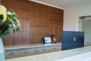 a laptop sitting on a counter in a room at MainStay Suites Whyalla in Whyalla