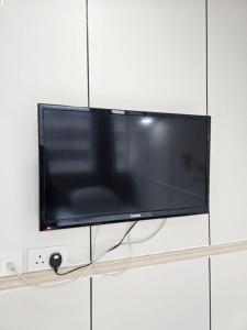 a flat screen tv hanging on a wall at K & B Hostel in Hong Kong