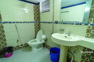 a bathroom with a toilet and a sink at Hotel Oasis International in Cox's Bazar +27 photos