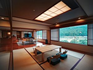 a large living room with a table and chairs at Kinugawa Hotel Mikazuki in Nikko
