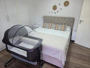 a bedroom with a bed with a baby crib at Raffaello's Villa in Vlorë +95 photos