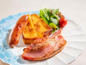 a plate of food with ham and toast and a salad at KAMENOI HOTEL Genkainada All-Inclusive Resort in Kitakyushu