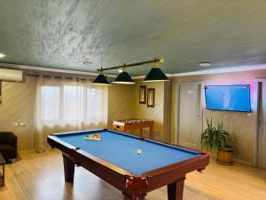 a living room with a pool table and a tv at Erida Guest House - къща за гости до Русе in Trastenik