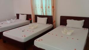 Postel nebo postele na pokoji v ubytování Mango Garden Hoi An Homestay