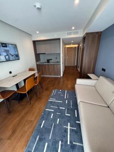 a living room with a couch and a table at Skyline Privilege in Marriott in Batumi +27 photos