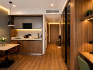 a kitchen and living room with a table and a counter at Skyline Privilege in Marriott in Batumi