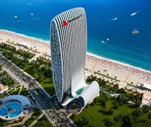 an aerial view of a tall building next to a beach at Skyline Privilege in Marriott in Batumi