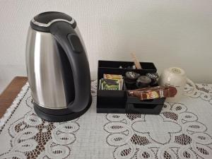 a coffee pot and a box of food on a table at Huize Beukenstein in Lochem