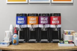 a shelf with four large bottles of liquids on a table at Hampton Inn Manhattan Grand Central in New York