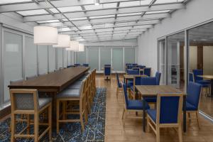 a conference room with wooden tables and blue chairs at Hampton Inn Manhattan Grand Central in New York