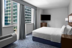 a hotel room with a bed and a large window at Hampton Inn Manhattan Grand Central in New York +31 photos