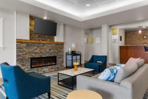 a living room with two couches and a fireplace at Comfort Inn & Suites Marion I-57 in Marion