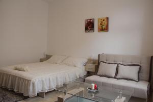 a living room with a bed and a couch at Apartments Matijašević in Nikšić