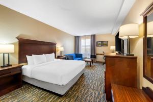 a hotel room with a bed and a television at Comfort Inn & Suites Branson Meadows in Branson +41 photos