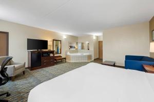 a hotel room with a bed and a television at Comfort Inn & Suites Branson Meadows in Branson