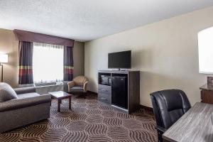 a hotel room with a couch and a tv at Quality Inn & Suites Salisbury South in Salisbury