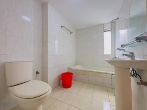 a white bathroom with a toilet and a sink at Impulse Ocean View in Cox's Bazar