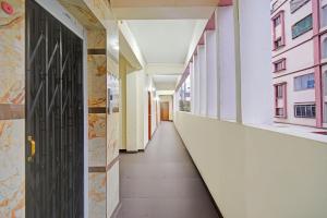 an empty corridor in a building with a door at Collection O ECIL Industrial Estate Formerly Hotel Cube in Maula Ali