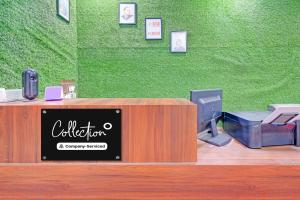 a cash register with a computer on top of it at Collection O ECIL Industrial Estate Formerly Hotel Cube in Maula Ali