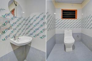 a bathroom with a toilet and a sink and a mirror at Collection O ECIL Industrial Estate Formerly Hotel Cube in Maula Ali