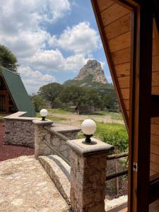 a porch with a view of a mountain at azomalli cabañas in Bernal