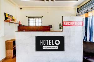 a hotel sign on a counter in a room at Hotel O SNIST University Hyderabad Formerly Hari Hara Enterprise in Maula Ali