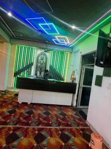 a man sitting at a counter in a room at HOTEL SHEKHAR INN Luxury Suit in Agra