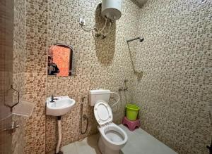 a bathroom with a toilet and a sink at HOTEL SHEKHAR INN Luxury Suit in Agra