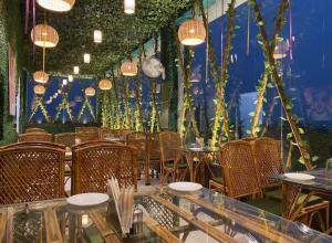 a dining room with tables and chairs and lights at HOTEL SHEKHAR INN Luxury Suit in Agra