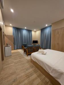 a hotel room with a bed and a table and chairs at Sugardunes Beach Resort in Ghadw