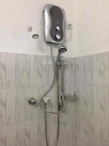 a shower with a shower head in a bathroom at E-Beach Resort in Negombo +21 photos