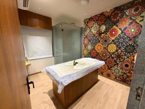 a room with a shower and a table with a towel at Hotel Royal Galleria in Vadodara +123 photos