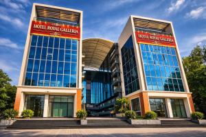 a building with two tall buildings with windows at Hotel Royal Galleria in Vadodara