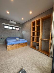 a bedroom with a bed and shelves in it at Big leaf villa cozy in Bangrak Beach +21 photos