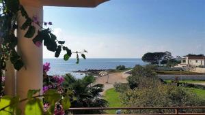 a view of the ocean from the balcony of a house at Apartments Lirio in Umag