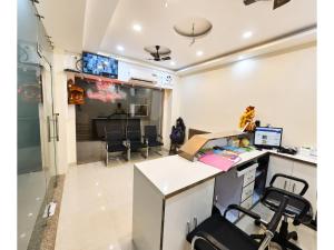 an office with a desk and chairs in a room at HOTEL MEDHYA GRAND Near Goḏawalia Chauraha - 200 Meter From Baba Vishwanath Temple & Ganga Arti Ghat ! Wi-Fi #Lift #Hygiene & Spacious Room - BEST HOTEL IN VARANASI in Varanasi