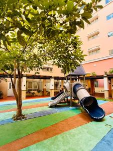 a playground in a building with a slide at JFam Suites, C1-5L 1BR , Up To 7 Pax in Biñan