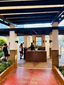 a group of people shaking hands in a lobby at JFam Suites, C1-5L 1BR , Up To 7 Pax in Biñan +62 photos