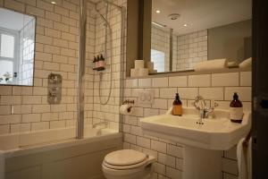 a bathroom with a toilet and a sink and a shower at The Lodges @ Barra Castle in Inverurie +82 photos