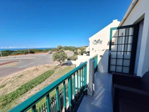 a balcony of a building with a view of a street at The Wave House on the Beach in Port Alfred