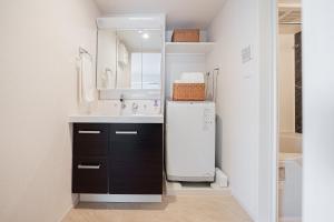 a small kitchen with a sink and a refrigerator at Maple Hotel Tokyo in Tokyo +75 photos
