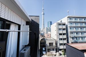 a view of a city with a tower in the background at Maple Hotel Tokyo in Tokyo